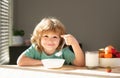 Caucasian toddler child boy eating healthy soup in the kitchen. Healthy nutrition for kids. Royalty Free Stock Photo