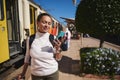 Caucasian tourist commuter woman at train station, using smartphone map, social media check-in, or buy ticket booking. Royalty Free Stock Photo