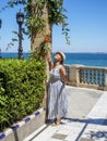 A woman enjoying a sunbathing on the Clara Campoamor Gardens, Cadiz, Spain