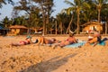 Caucasian Tourists and families relaxing and enjoying on the beach at Agonda Beach in Goa, India