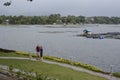 Caucasian tourists visit improvised house shanty built on a lake