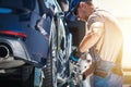 Tow Truck Driver Securing the Car with Transport Belts Royalty Free Stock Photo