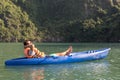 Caucasian traveler relaxing in a blue kayak down serene waters