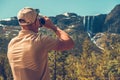 Traveler Watching Mountainscape with Binoculars