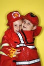 Caucasian twin boys dressed as firemen. Royalty Free Stock Photo