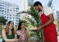 Caucasian waiter serving french fries to guests in a restaurant Royalty Free Stock Photo