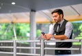 Caucasian white business man look at his mobile phone and stand at sky train walk way, also expressed sad emotion during day time Royalty Free Stock Photo