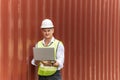 Caucasian white businessman or engineer control worker working on digital laptop computer with cargo container Royalty Free Stock Photo