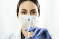 Doctor or nurse woman holds injection syringe and vaccine Royalty Free Stock Photo