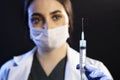 Doctor or nurse woman holds injection syringe and vaccine Royalty Free Stock Photo