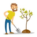 Young caucasian white gardener plants a tree.