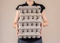 Caucasian woman with black shirt holding four cardboard egg boxes full of chicken eggs Royalty Free Stock Photo