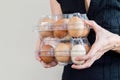 Caucasian woman with black shirt holding two plastic egg boxes full of chicken eggs Royalty Free Stock Photo