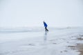 Caucasian woman in a blue sweater is skating on a frozen lake. The figure skater performs the program. Royalty Free Stock Photo