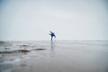 Caucasian woman in a blue sweater is skating on a frozen lake. Figure skater performs a swallow. Royalty Free Stock Photo