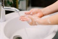 caucasian woman carefully washing hands with soap and sanitiser at home during worldwide coronavirus pandemic