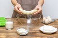 Caucasian woman chef in apron preparing ingredients for making cottage cheese muffins cupcakes casserole at home kitchen Royalty Free Stock Photo