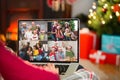 Caucasian woman with christmas decorations having video call with happy diverse family Royalty Free Stock Photo