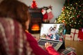 Caucasian woman with christmas decorations having video call with happy caucasian family Royalty Free Stock Photo