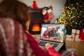 Caucasian woman with christmas decorations having video call with happy caucasian family Royalty Free Stock Photo