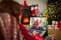 Caucasian woman with christmas decorations having video call with happy senior caucasian couple Royalty Free Stock Photo