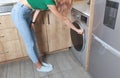 Caucasian woman close the door of washing machine