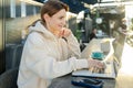 Caucasian woman connecting to 4g wireless internet on modern netbook computer, Young hipster girl working on laptop in Royalty Free Stock Photo