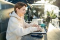 Caucasian woman connecting to 4g wireless internet on modern netbook computer, Young hipster girl working on laptop in Royalty Free Stock Photo