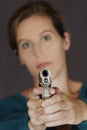 Caucasian woman defending herself using a handgun