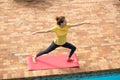 Woman doing yoga outdoor. Stretching exercise on vacation