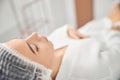 Caucasian woman feeling relaxed on medical couch