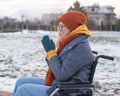 Caucasian woman freezes in a wheelchair in winter. Royalty Free Stock Photo