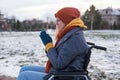 Caucasian woman freezes in a wheelchair in winter. Royalty Free Stock Photo