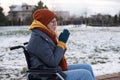 Caucasian woman freezes in a wheelchair in winter. Royalty Free Stock Photo