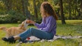 Caucasian woman girl owner happy laughing playing with funny little welsh corgi puppy dog trying to catch apple female Royalty Free Stock Photo