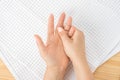 Caucasian woman with hand on her unhealthy finger and palm. Self massage, office syndrome and musclar pain. Closeup hand of person