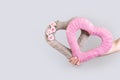 Caucasian woman hand holds two burlap hearts. Hearts on light grey background Royalty Free Stock Photo