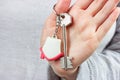 Caucasian woman hands holding the keychain with the keys and small house key ring close up. Apartment renter, real estate Royalty Free Stock Photo