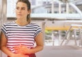 Caucasian woman having painful stomachache,Female suffering from abdominal pain,Period cramps or premenstral syndrome outdoor,Copy Royalty Free Stock Photo