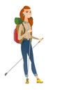 Caucasian woman hiker walking with trekking sticks