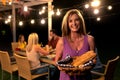 Caucasian woman holding a basket of bread and smiling to camera Royalty Free Stock Photo