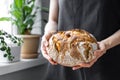 caucasian woman holding fresh bread from the oven, baking homemade bread Royalty Free Stock Photo