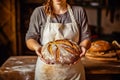 Caucasian woman holding fresh bread from the oven, baking homemade bread. Close up Royalty Free Stock Photo