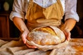 Caucasian woman holding fresh bread from the oven, baking homemade bread. Close up Royalty Free Stock Photo