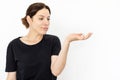 Caucasian woman holding invisible object on palm Royalty Free Stock Photo