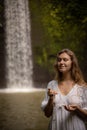 Caucasian woman keeping count during pray and meditation. Buddhist japa mala. Strands of gemstones beads. Religion concept.