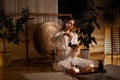 Caucasian woman in kimono performing a traditional Chinese tea ceremony using a Tibetan singing bowl Royalty Free Stock Photo