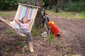 Caucasian woman lies in a hammock in a pine forest