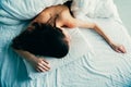 Caucasian woman lying in bed sleeping, her messy hair on pillow Royalty Free Stock Photo