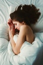 Caucasian woman lying in bed sleeping, her messy hair on pillow Royalty Free Stock Photo